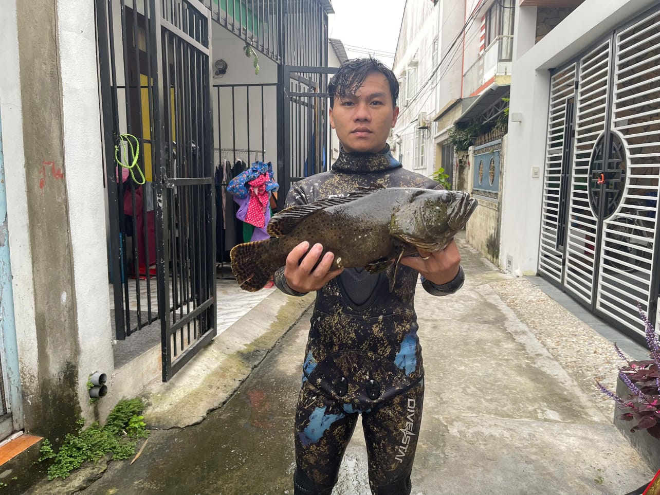 Guest holding a large fish after the Hoi An fishing tour
